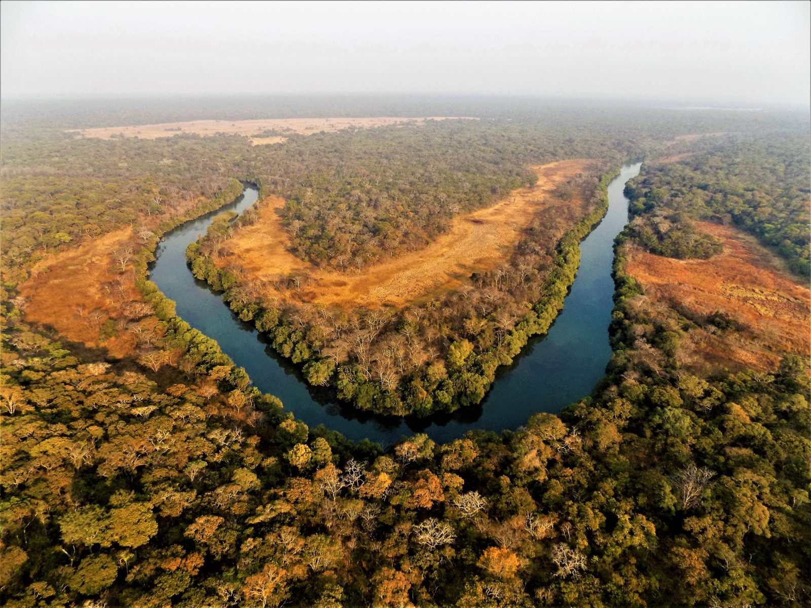 Two rivers converging through the forests of Chibwika Chiefdom, aerial view